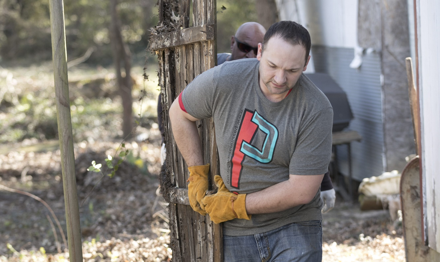 Man carrying scrap lumber